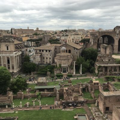 The central part of the Forum Archaeological Area. Right to left in background: the Basilica of Maxentius, the so-called Temple of Romulus, and the Temple of Antoninus and Faustina. The House of the Vestals is in the foreground.
