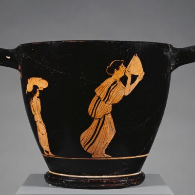 A woman emptying a large skyphos. At symposia, drinking contests would use such vessels.